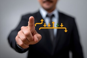A man in a suit is pointing at a chart with arrows and a green arrow