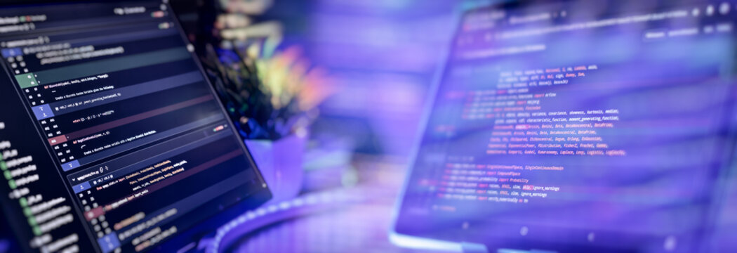 Python programming on dual monitors in tech workspace