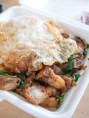 Crispy Pork Basil with Fried Egg in Foam Box Takeaway.