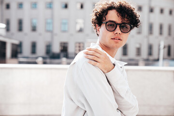 Portrait of young attractive man with curly hair hairstyle. Confident handsome male in casual...