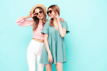 Two young beautiful smiling brunette hipster female in trendy summer dresses. Sexy carefree women...
