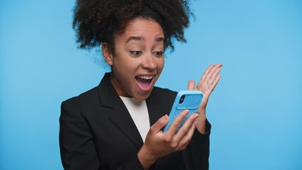 Excited woman reacts to job offer on phone on blue