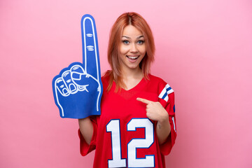 Young Russian rugby fan girl isolated on pink background with surprise facial expression