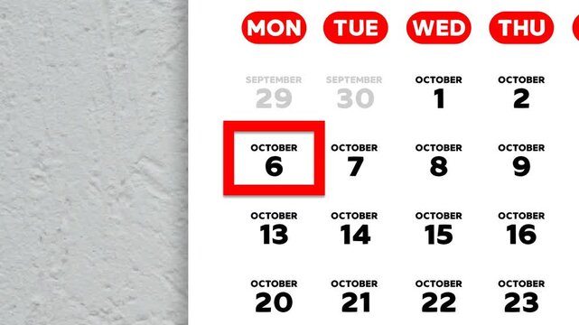 The date October 6th marked with a red cursor on the wall calendar 2025