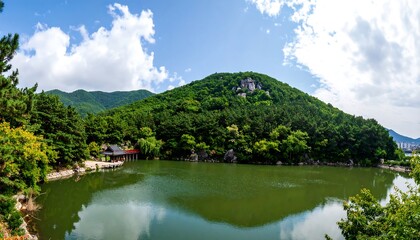 Serene lake nestled amongst lush green hills under a vibrant sky.