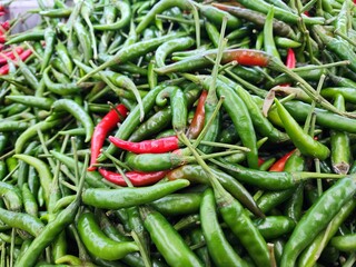 Close-Up of Fresh Red and Green Chili Peppers at a Market Stand