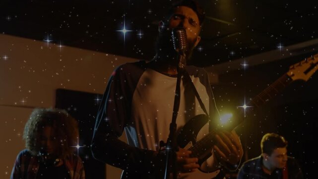 Drummer grooving on drum causing star overlay framing singer strumming guitar in band scene