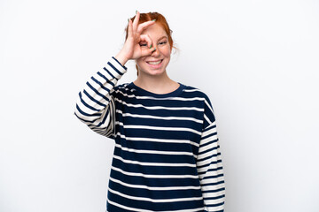 Young reddish woman isolated on white background showing ok sign with fingers