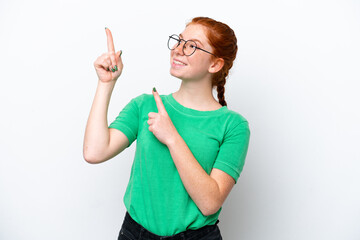 Young reddish woman isolated on white background pointing with the index finger a great idea