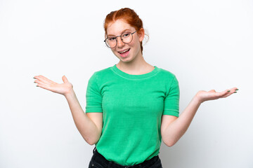 Young reddish woman isolated on white background with shocked facial expression
