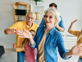 Portrait of a three generation famili, grandparents, parents and children playing and having fun...