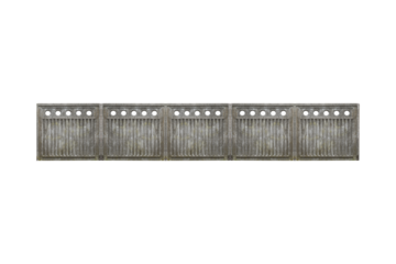 Long concrete fence with vertical bars and round holes is isolated.