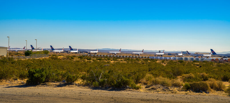 Victorville, California, USA - November 11, 2023 : Parked commercial airplanes lined up in storage at Southern California Logistics Airport in Victorville, California.