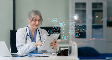 Medical Technology Concepts The doctor is working on a tablet and audio player and a digital tablet computer in a modern office in the morning at the desk.