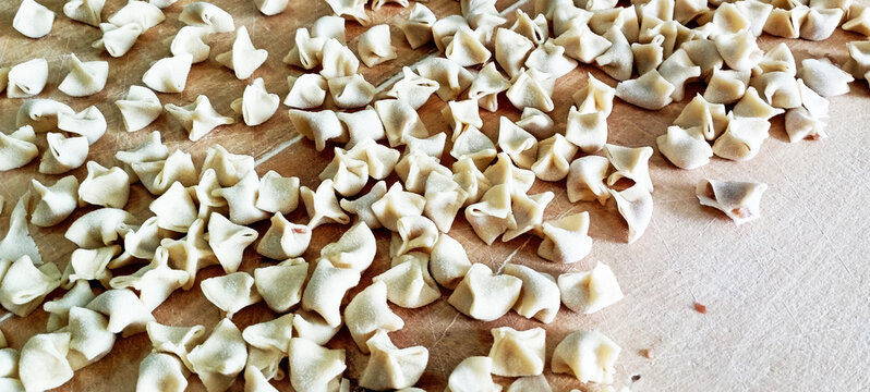 manti ( turkish ravioli type dumplings )served with garlic yoghurt, melted aleppo pepper butter and dry mint and sumac