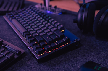 gamer workspace concept, top view a gaming gear, mouse, keyboard, joystick, headset on black table background