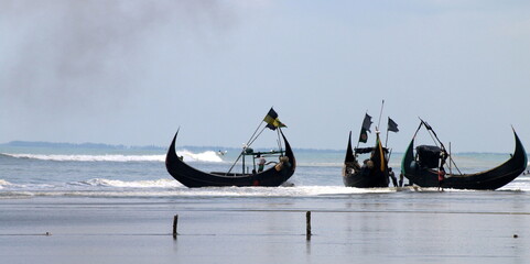 Cox'sbazar, Bangladesh- July 10, 2016: Anchored fishing boat in the sea beach of the Bay of Bengal. The longest natural unbroken sea beach.