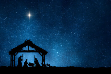 Elegant black silhouettes of the Christmas Nativity scene against a magnificent starry night sky backdrop symbolizing the holy night