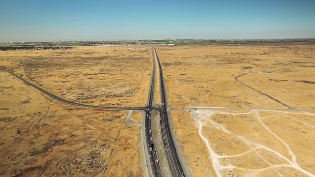 Aerial drone view of desert highway through dry plains, Idaho USA