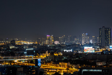 Fototapeta premium Blurred background of night lights in Bangkok. Fireworks, traffic lights, lights on bridges over the river, the spread of electric lighting technology in homes.