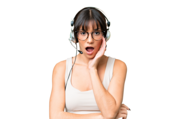 Telemarketer caucasian woman working with a headset over isolated background surprised and shocked while looking right