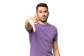 Young handsome caucasian man over isolated background showing thumb down with negative expression