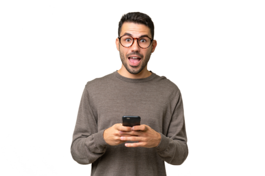 Young handsome caucasian man over isolated background surprised and sending a message - Powered by Adobe