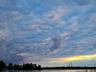 Dramatic evening blue and grey sky over river