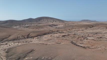 desert place where the scarce vegetation meets the mountains and the sand 