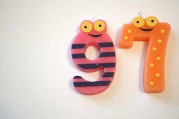 Number 97 party candle isolated on white background, close-up with copy space.