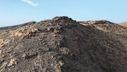 desert place where the scarce vegetation meets the mountains and the sand 