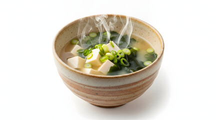 A steaming bowl of traditional Japanese miso soup with tofu, wakame seaweed, and chopped green onions, served in a rustic ceramic bowl on a white background.