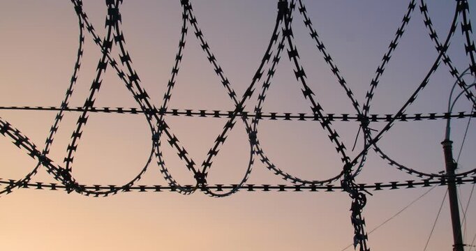 Background tracking shot of the cloudless sky over barbed wire for use in a composition for titles or titles, empty space for text or inscription.