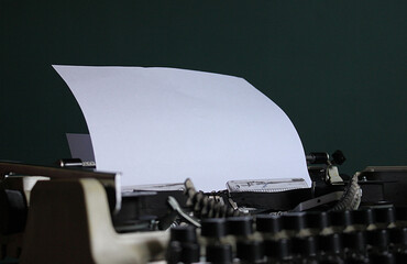 White blank sheet of paper in a typewriter for writers, poets, writing literary works. Prose, poetry, novels, poems. Professional equipment. Art and creativity. School stuff. Fiction, fairy tales