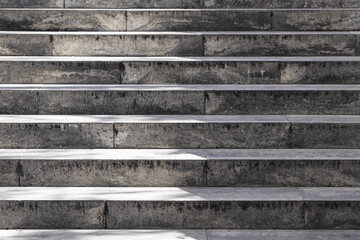 Old stone staircase with weathered surface. Concrete steps in outdoor urban environment. Historic...