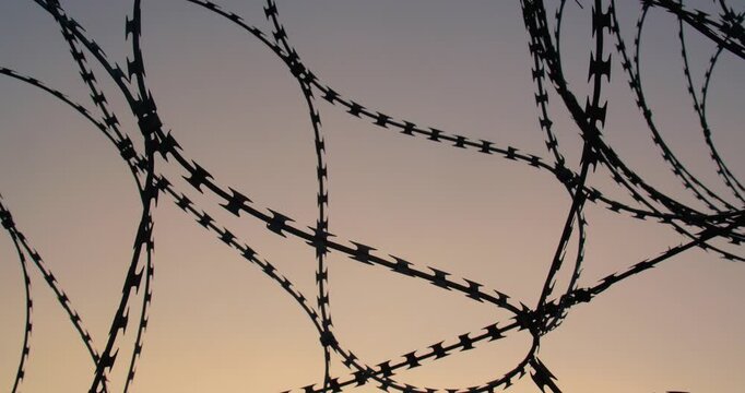 Background tracking shot of the cloudless sky over barbed wire for use in a composition for titles or titles, empty space for text or inscription.