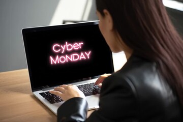 Woman at laptop with cyber monday written on screen