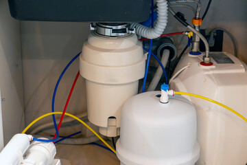 Complete under-sink setup with reverse osmosis water filtration system, food waste disposer, and...