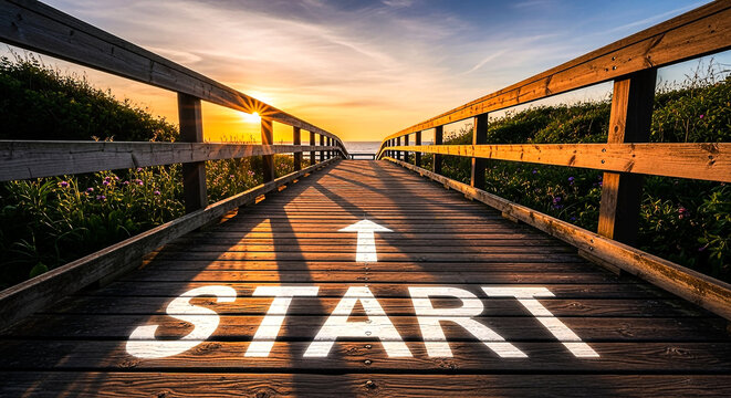 Wooden boardwalk leads to a bright sunset with the word start illuminated on the path symbolizing new beginnings and opportunities