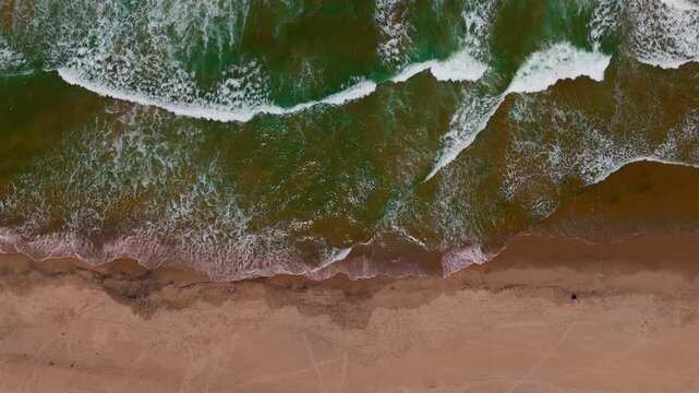 Aerial Beach Scene with Tiny Fisherman and White Waves at Hikkaduwa