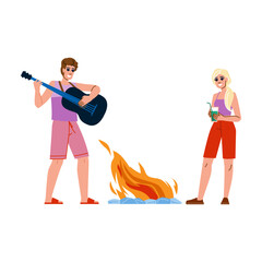 Friends playing guitar and drinking cocktails at bonfire party