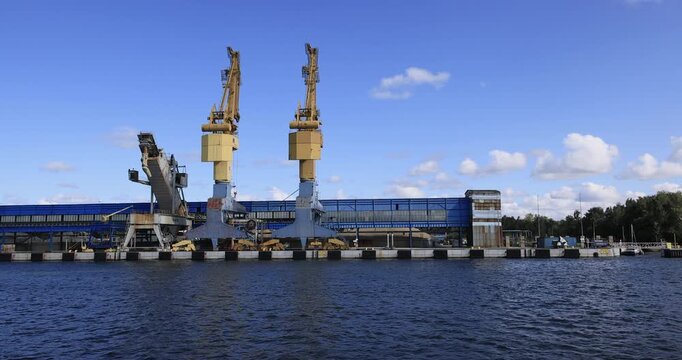 Gdansk Poland water front industrial cargo port cranes 4K. Baltic coast of northern Poland. World War II started here with German invasion. Economic international port. Historical buildings, tourism.