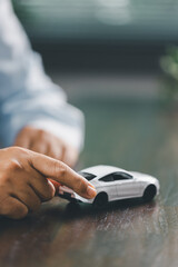 Car loan approval concept. Client finalizes purchase of vehicle by signing contract includes auto...