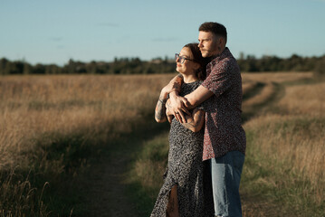 A loving couple shares a tender moment while enjoying a beautiful day outdoors.