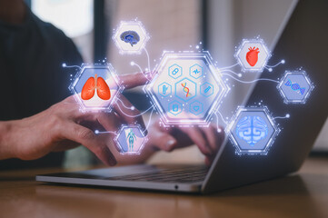 Close up of hands typing on laptop with floating medical holograms showing lungs, brain, heart, and DNA, symbolizing AI healthcare telemedicine medical research digital health innovation technology