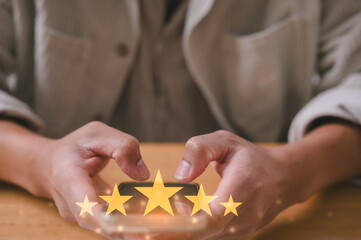 Customer service experience and satisfaction survey concept Close up of man customer sitting in cafe or restaurant giving a five star rating on smartphone. Review, Service rating, satisfaction