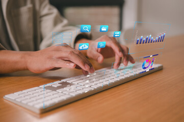 Close-up of hands typing on a keyboard with virtual digital icons, data analytics charts, and cloud computing interface, representing technology, big data, and business innovation.