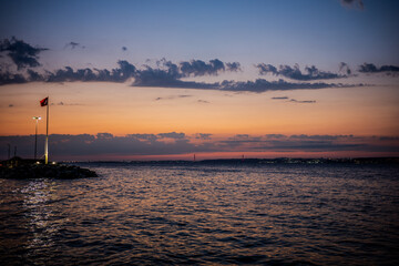 Turkish flag by the sea at sunset