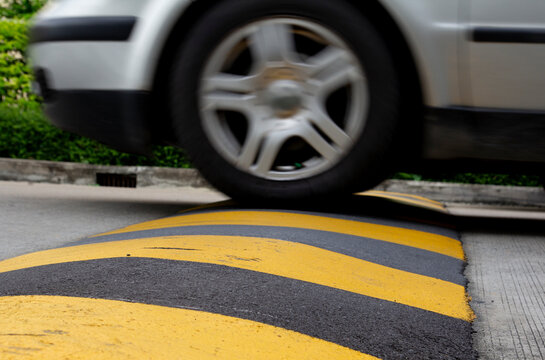 city car speed limit , speed bump on road to reduce fast car - Powered by Adobe
