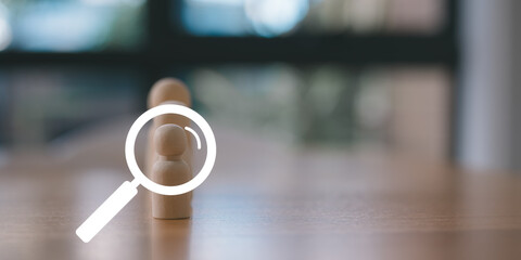 Wooden human figure with magnifying glass overlay on blurred background, symbolizing recruitment, job search, HR selection, employee evaluation, candidate analysis, and business hiring process.
